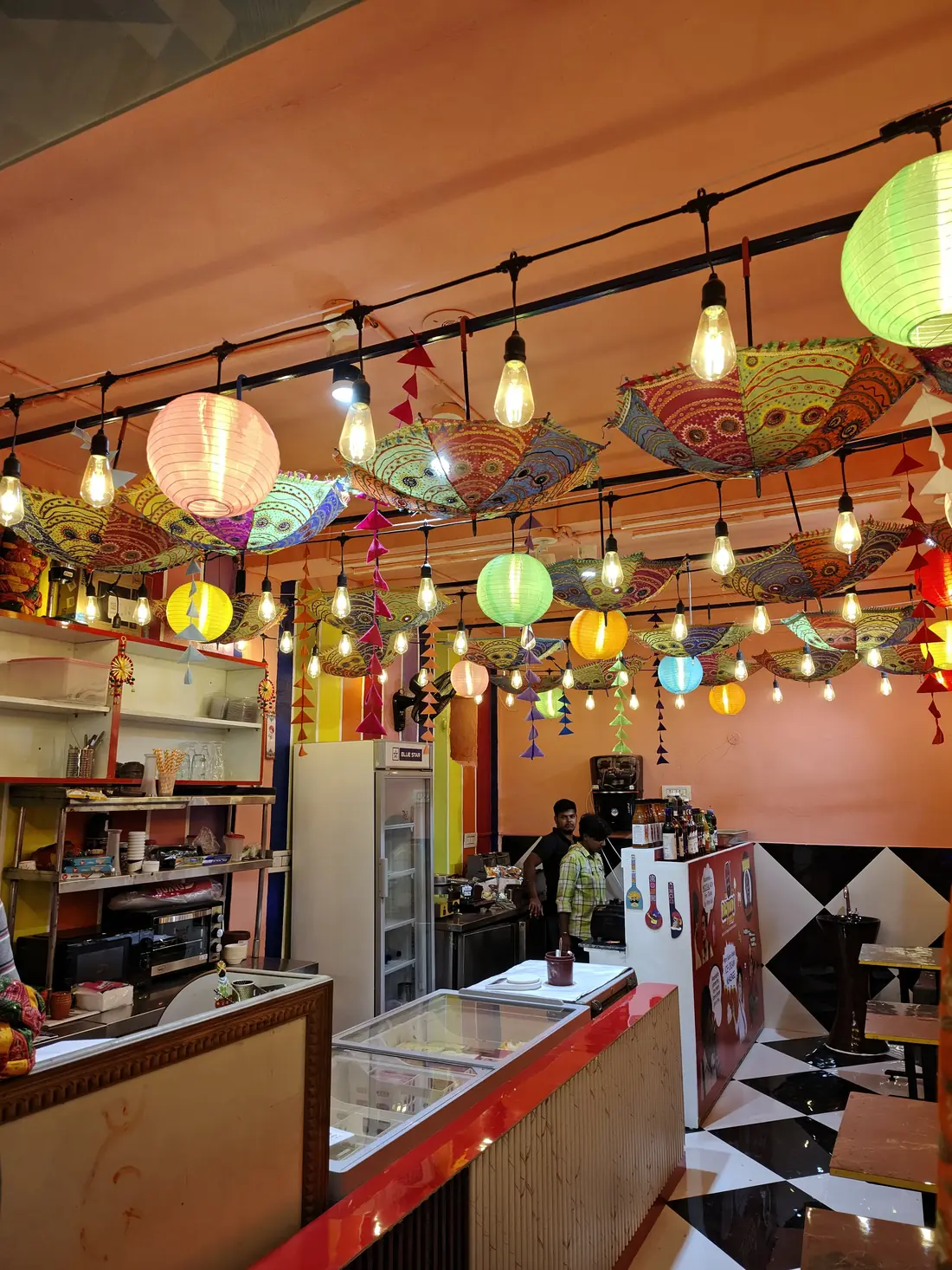 The Rajvadi Storiez interior with hanging Rajasthani umbrellas and paper lanterns